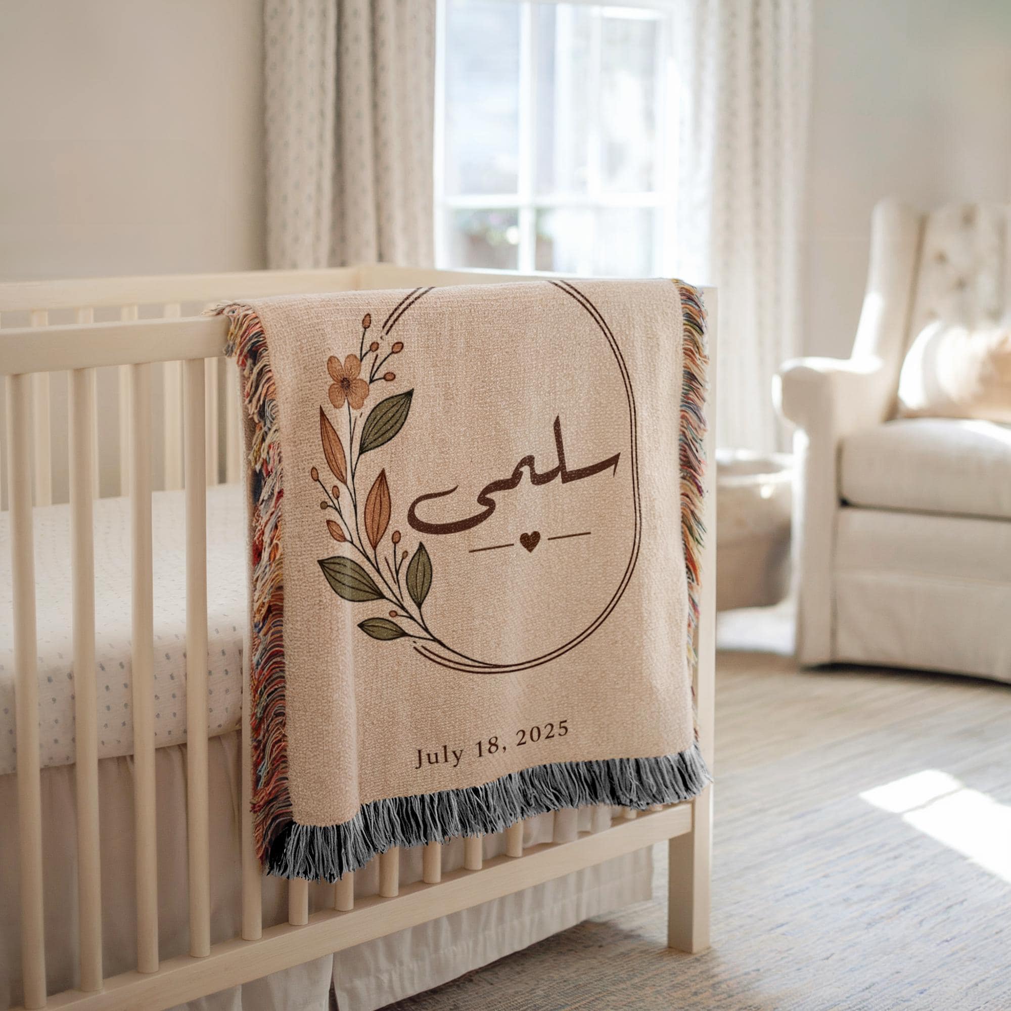 Arabic calligraphy blanket draped over a white crib, with a floral oval frame and date visible, set in a brightly lit nursery background.