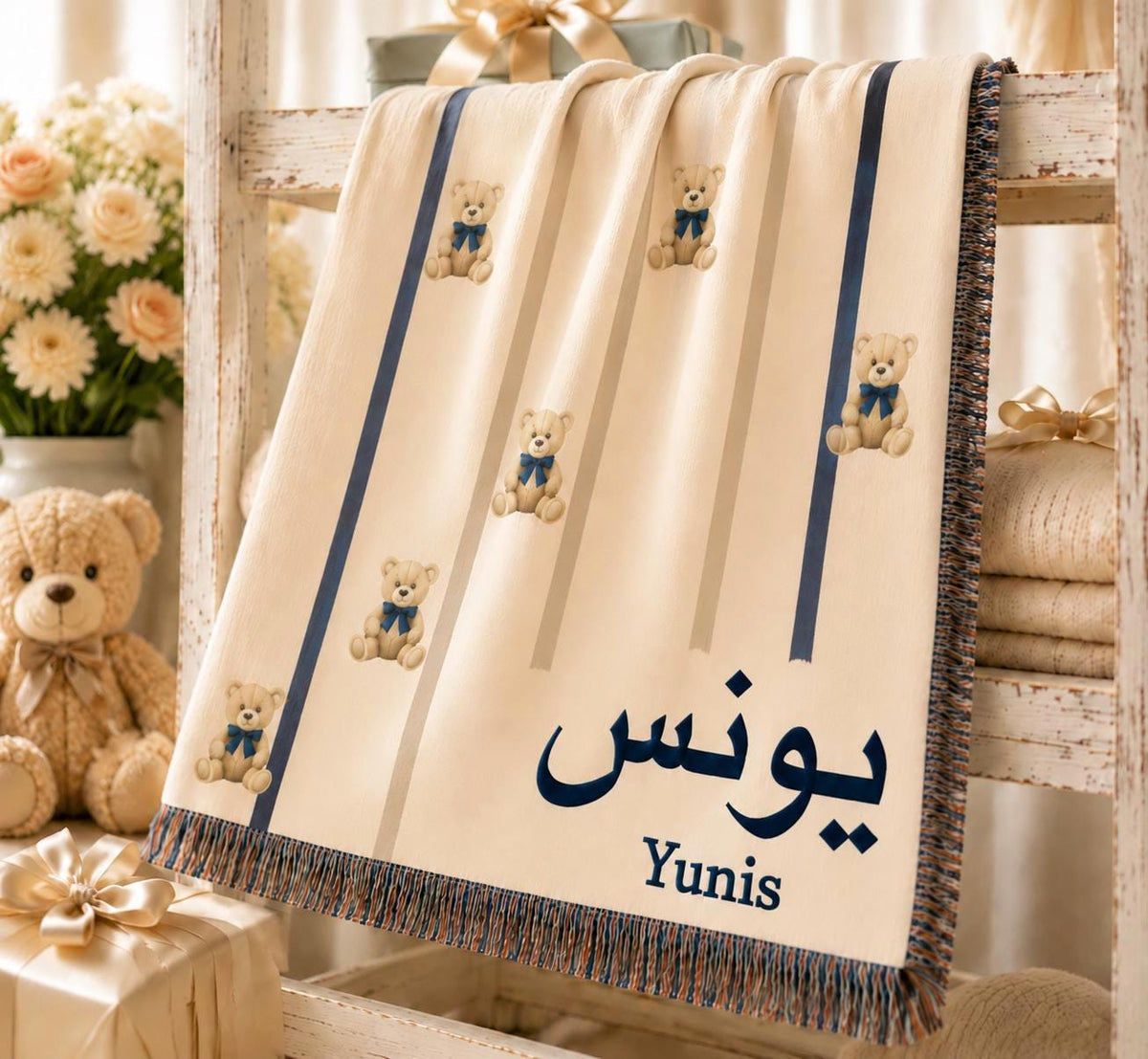 Personalized baby blanket with a teddy bear, navy ribbon, and custom Arabic name, draped over a plush teddy bear.